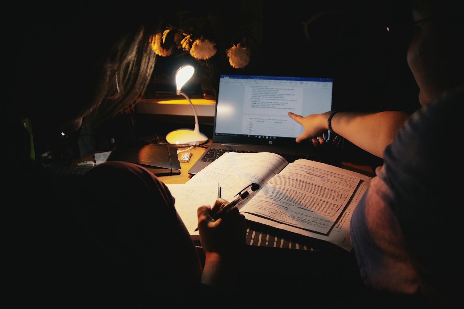 Student organizing class notes into structured flashcards with a laptop